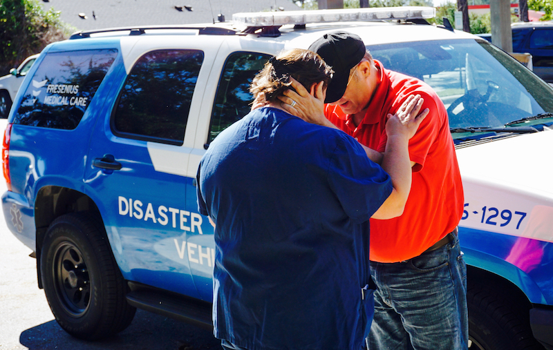FMC Disaster Response team consoling a grieving resident 